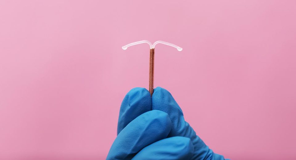 iud contraceptive method Doctor holding T-shaped intrauterine birth control device