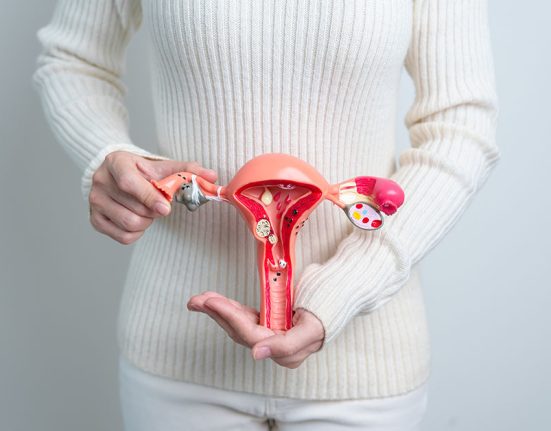 Woman holding Uterus and Ovaries model. Ovarian and Cervical cancer, Cervix disorder, Endometriosis, Hysterectomy, Uterine fibroids, Reproductive system and Pregnancy concept